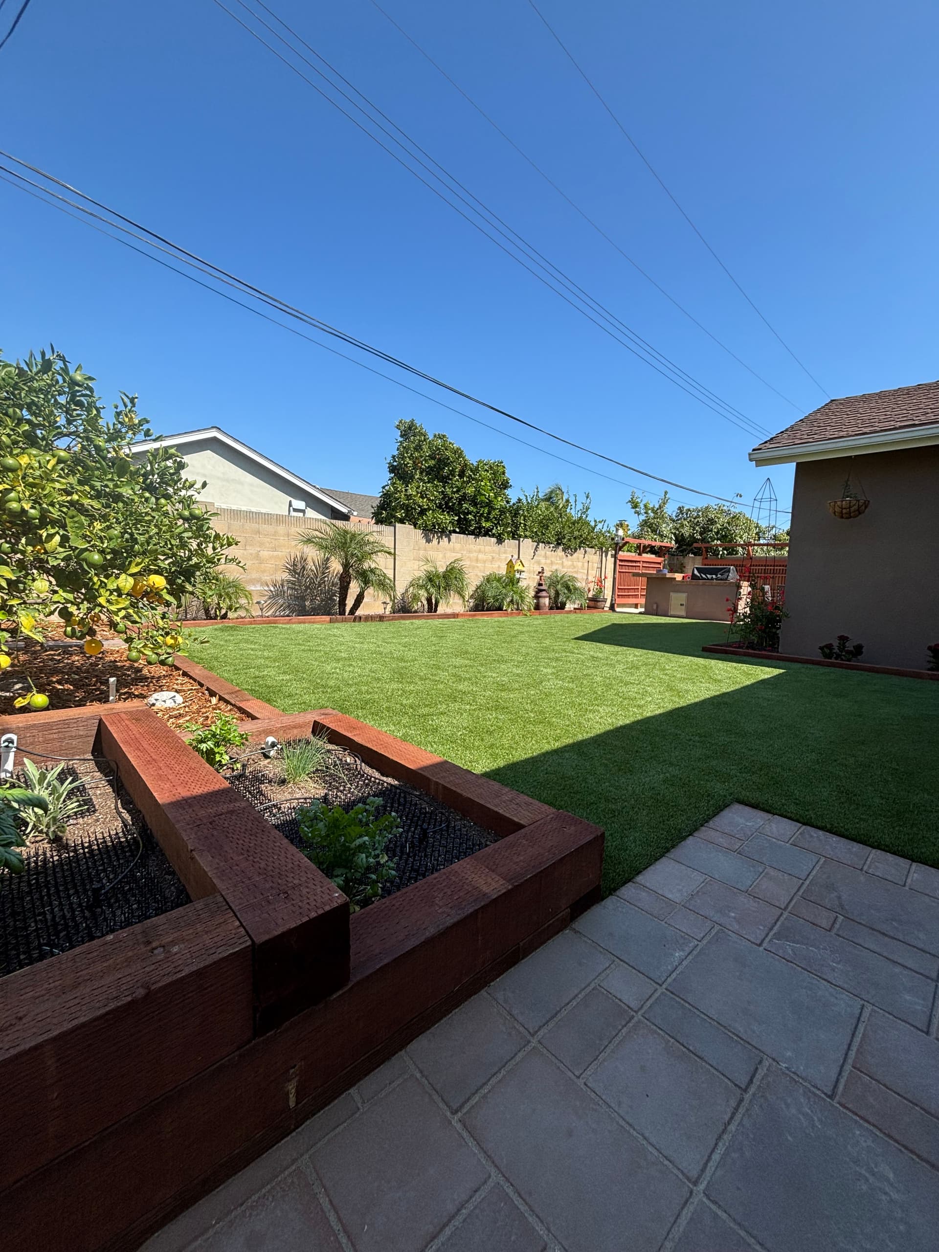 Huntington Beach Backyard Gets Pavers, Turf, and a Block Wall